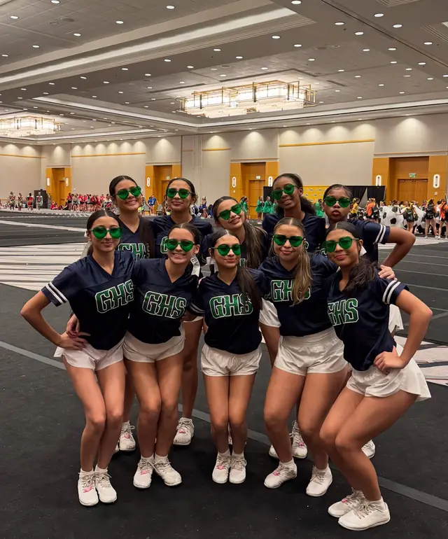 The squad in matching shirts and green sunglasses at camp
