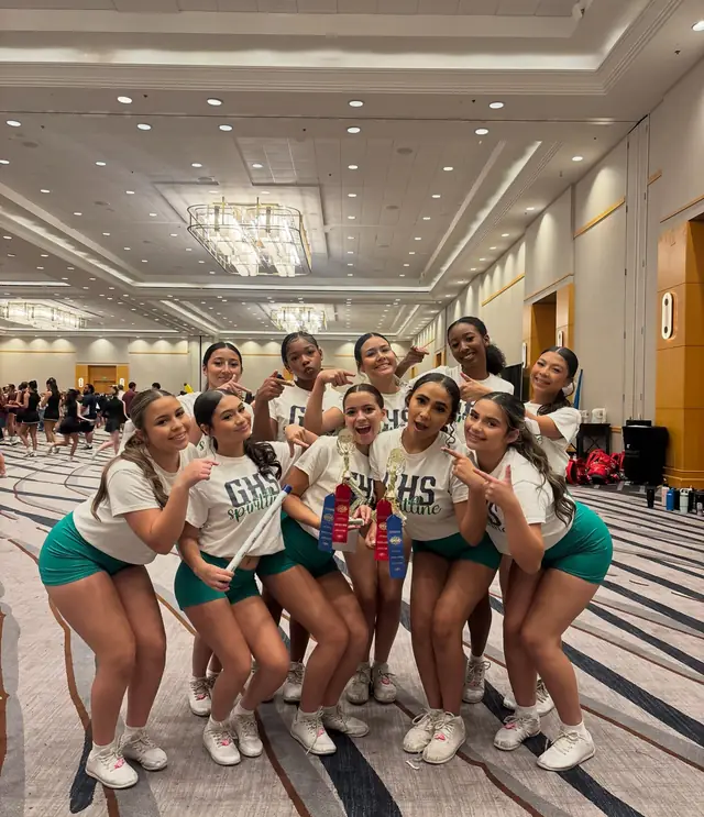 The squad showing off their UCA camp trophies and ribbons, July 2026