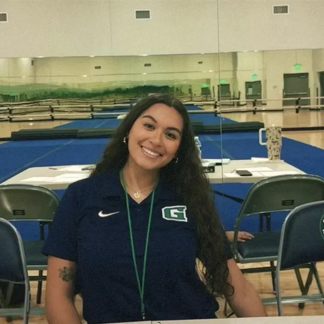 Coach Brianna Martinez in a Goodyear High polo in the school's gym