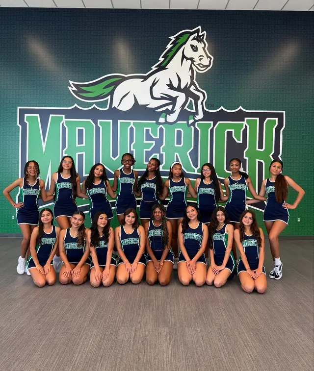 The first Goodyear squad posing in front of the Maverick mural