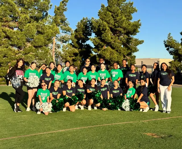 Goodyear's cheer and pom teams with their poms on the lawn on Cardinals game day, October 2025