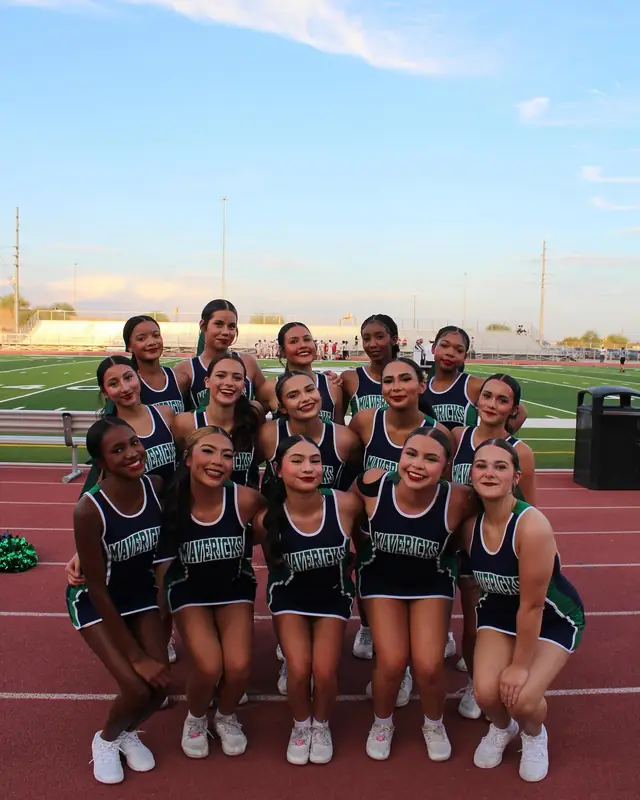 The squad kneeling together on the track at the August 2026 home opener