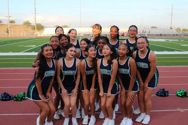 The 2026–27 Goodyear cheer squad together on the track at the stadium